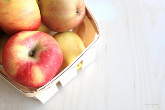 Basket of apples on wooden table